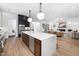Modern kitchen boasts a large island, wooden cabinetry, and seamless flow to the living room at 604 Edmund St, Raleigh, NC 27604