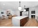 Open-concept kitchen featuring a large marble island, stainless appliances and hardwood floors at 604 Edmund St, Raleigh, NC 27604