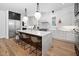 Spacious kitchen featuring an island with seating, stainless appliances and pendant lighting at 604 Edmund St, Raleigh, NC 27604