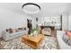 Open-concept living room flowing into a modern kitchen with high-end appliances and a breakfast bar at 604 Edmund St, Raleigh, NC 27604