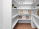 Walk-in pantry with white shelving and hardwood floors, providing ample storage space at 604 Edmund St, Raleigh, NC 27604