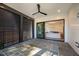 Covered patio with stone flooring, ceiling fan, and view of the living room at 604 Edmund St, Raleigh, NC 27604