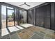 Enclosed patio with stone flooring, large sliding glass doors, and outdoor views at 604 Edmund St, Raleigh, NC 27604