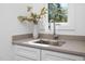 Bright, modern sink with stainless steel faucet, gray countertop and window view at 604 Edmund St, Raleigh, NC 27604