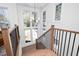 Bright staircase with wood treads, iron railings, and a large window showcasing the home's exterior at 604 Edmund St, Raleigh, NC 27604
