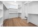 Spacious walk-in closet with custom shelving and storage solutions and hardwood floors at 604 Edmund St, Raleigh, NC 27604