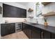 Stylish wet bar featuring dark cabinetry, stone countertops, and modern fixtures for entertaining at 604 Edmund St, Raleigh, NC 27604