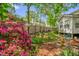 Backyard featuring lush garden, a fenced perimeter, and a charming seating area, ideal for relaxation at 605 Wyndham Dr, Fuquay Varina, NC 27526