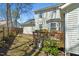 Charming backyard with a wooden deck, green lawn, mature trees, and a wooden fence at 605 Wyndham Dr, Fuquay Varina, NC 27526