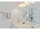 Bright bathroom with double sinks, a large mirror, and a modern shower with marble patterned walls at 605 Wyndham Dr, Fuquay Varina, NC 27526