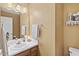 Well-lit bathroom with a vanity, mirror, and essential fixtures at 605 Wyndham Dr, Fuquay Varina, NC 27526