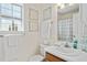 Bright bathroom with a white sink, framed art, window, and neutral walls, providing a clean and inviting space at 605 Wyndham Dr, Fuquay Varina, NC 27526