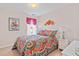 Charming bedroom featuring a colorful bedspread, complementing bedside tables, and soft, pink-painted walls at 605 Wyndham Dr, Fuquay Varina, NC 27526