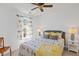 Cozy bedroom featuring a comfortable bed, stylish bird-themed bedding and window treatments, and a ceiling fan at 605 Wyndham Dr, Fuquay Varina, NC 27526