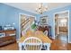 Bright dining room with chandelier, hardwood floors, and stairs leading to upper level at 605 Wyndham Dr, Fuquay Varina, NC 27526