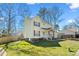 Charming two-story home featuring cream siding, brick accents and a well-manicured front lawn at 605 Wyndham Dr, Fuquay Varina, NC 27526