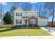 Charming two-story home with red shutters, brick accents, attached garage, and well-maintained lawn at 605 Wyndham Dr, Fuquay Varina, NC 27526
