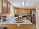 Charming kitchen with stainless steel appliances and wood cabinets, perfect for home cooking at 605 Wyndham Dr, Fuquay Varina, NC 27526