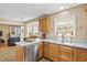 Cozy kitchen featuring stainless steel appliances, granite countertops, and a large window at 605 Wyndham Dr, Fuquay Varina, NC 27526
