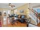 Inviting living room showcasing hardwood floors, a staircase, and ample seating space at 605 Wyndham Dr, Fuquay Varina, NC 27526