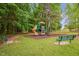 Community playground with a slide and play structure, complemented by benches and green surroundings at 605 Wyndham Dr, Fuquay Varina, NC 27526