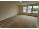 Spacious bedroom with carpet flooring and natural light from three windows at 6405 Granite Quarry Dr, Raleigh, NC 27610