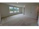 Bright primary bedroom with carpet flooring and multiple windows at 6405 Granite Quarry Dr, Raleigh, NC 27610