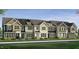 Row of charming townhomes featuring varied color palettes, complemented by manicured landscaping at 6405 Granite Quarry Dr, Raleigh, NC 27610