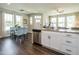 Open-concept kitchen and dining area featuring granite countertops, stainless steel appliances, and hardwood floors at 6405 Granite Quarry Dr, Raleigh, NC 27610