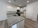 Kitchen features granite countertops, stainless steel appliances, and white cabinetry at 6405 Granite Quarry Dr, Raleigh, NC 27610
