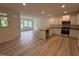 Open-concept kitchen features stainless appliances, granite countertops, and an island with a sink at 6405 Granite Quarry Dr, Raleigh, NC 27610
