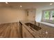 Close-up of kitchen island with stainless faucet, granite countertop, and stainless dishwasher at 6405 Granite Quarry Dr, Raleigh, NC 27610