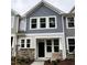 Charming two-story townhome featuring stone accents, neutral siding, and a covered front porch at 6407 Granite Quarry Dr, Raleigh, NC 27610