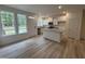 Bright kitchen featuring white cabinets, stainless steel appliances, and a center island with granite countertops at 6407 Granite Quarry Dr, Raleigh, NC 27610
