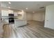 Bright kitchen featuring white cabinets, stainless steel appliances, and a center island with granite countertops at 6407 Granite Quarry Dr, Raleigh, NC 27610