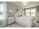 Serene bedroom featuring neutral tones, plush bedding, and ample natural light from surrounding windows at 6409 Granite Quarry Dr, Raleigh, NC 27610