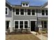 Charming townhouse with stone accents, neutral siding, and bright white-framed windows at 6409 Granite Quarry Dr, Raleigh, NC 27610