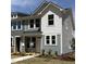 Charming two-story home with white siding, large windows, and a well-manicured lawn at 6411 Granite Quarry Dr, Raleigh, NC 27610