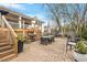 Charming backyard with a large brick patio, dining sets, and lush greenery, perfect for outdoor living at 711 S East Street St, Raleigh, NC 27601