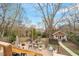 Spacious backyard features a deck, brick patio, outdoor furniture, and a charming detached guest house at 711 S East Street St, Raleigh, NC 27601
