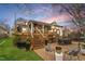 Inviting backyard featuring a wooden deck, brick patio, and outdoor dining area for relaxation at 711 S East Street St, Raleigh, NC 27601
