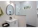 Modern bathroom with walk-in shower, subway tile, sleek fixtures and a framed oval mirror at 711 S East Street St, Raleigh, NC 27601