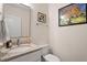 Stylish half-bathroom featuring modern fixtures, a sleek vanity, and decorative art, adding character to the space at 711 S East Street St, Raleigh, NC 27601