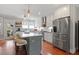 A modern kitchen with white cabinets, stainless steel appliances, and a gray island with seating at 711 S East Street St, Raleigh, NC 27601