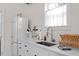 The kitchenette features a clean design, white cabinets, stainless steel sink and modern appliances at 711 S East Street St, Raleigh, NC 27601