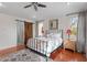 A bedroom featuring hardwood floors, modern décor, and a sliding door to the main bathroom at 711 S East Street St, Raleigh, NC 27601