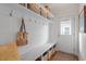Functional mudroom with storage shelves, hooks, and a bench providing an organized entry point to the home at 711 S East Street St, Raleigh, NC 27601
