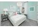 Bright bedroom with stylish decor, featuring a chandelier, a plush bed, and seaside-inspired artwork at 720 Ben Ledi Ct, Raleigh, NC 27603