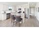 Bright, open kitchen with white cabinets, stainless steel appliances, and a marble island with seating at 720 Ben Ledi Ct, Raleigh, NC 27603