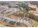 Aerial view of a community featuring multiple houses, ponds, and tree-lined streets at 724 Red Arrow Dr, Knightdale, NC 27545